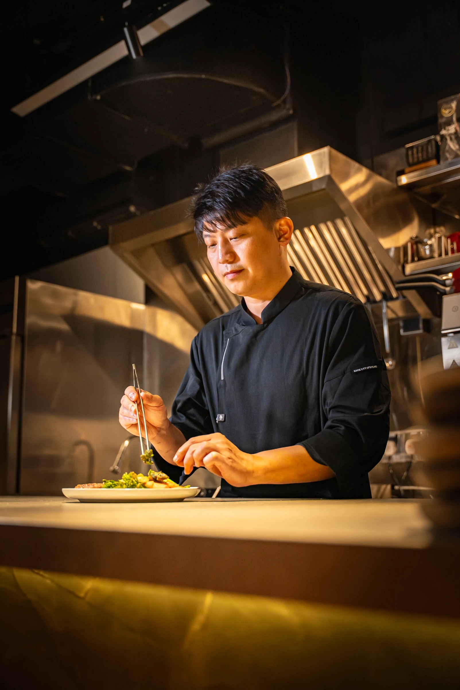 Cavemen Social — Chef Finishing Dish